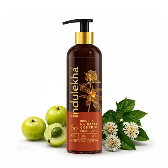 Indulekha Bringha Hairfall Control shampoo bottle with amla fruit and bhringraj flowers